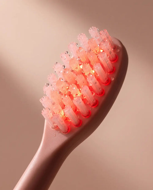 BeamBrush bristle head close-up, 660nm and 830nm LEDs glowing